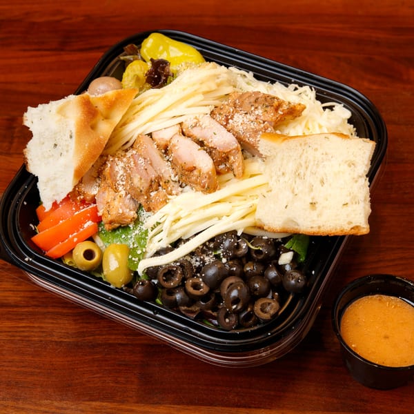 Cortina's Italian Market & Pizzeria's chicken salad with olives, peppers, tomatoes, cheese, and bread.