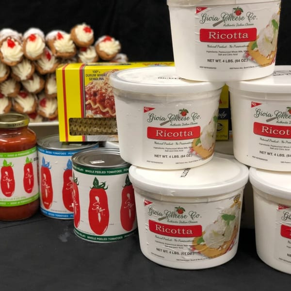 Cannolis, lasagna, tomato sauce, canned tomatoes, and large tubs of ricotta cheese.