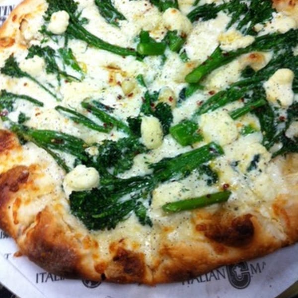 A white pizza from Cortina's Italian Market & Pizzeria, topped with broccoli rabe and cheese.